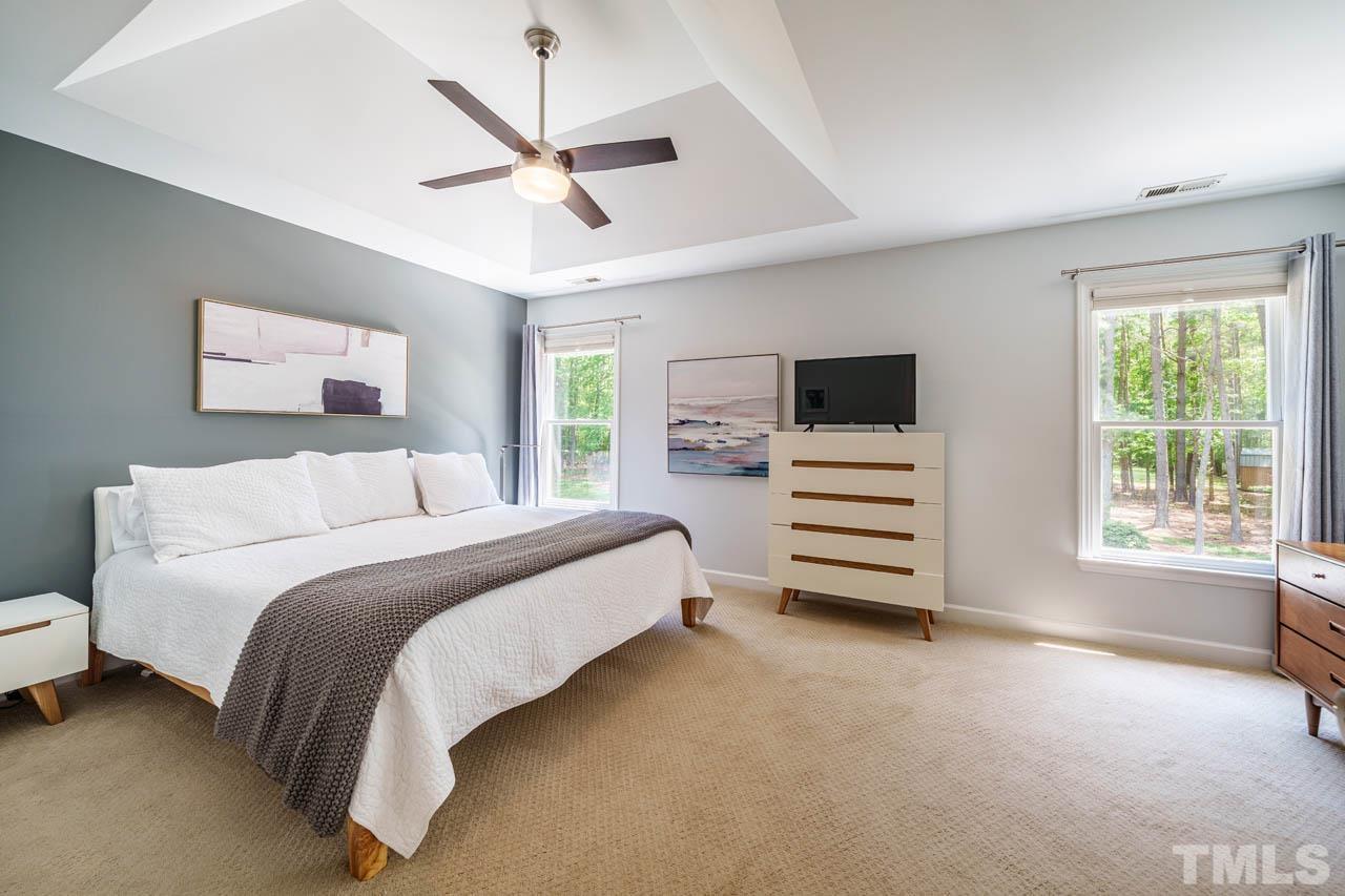 325 Morris Road Pittsboro, NC 27312 - Photo 17 of 39 a bedroom with a bed a window and a ceiling fan