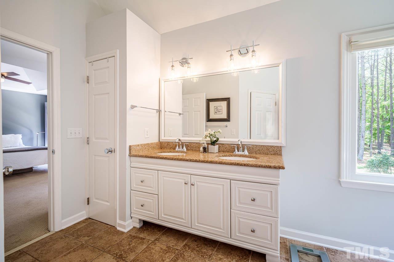 325 Morris Road Pittsboro, NC 27312 - Photo 18 of 39 a en suite bathroom with a granite countertop sink and a mirror