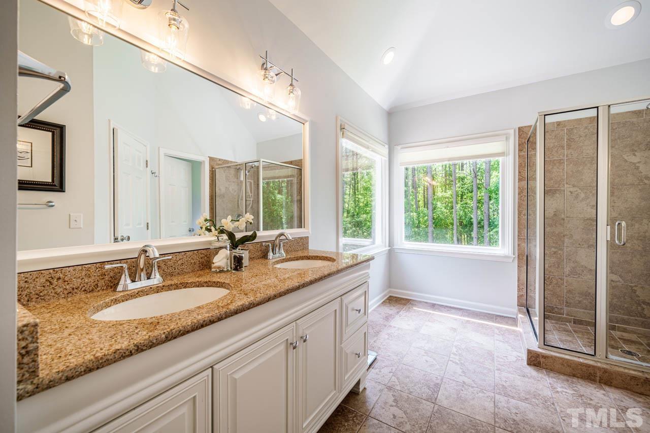 325 Morris Road Pittsboro, NC 27312 - Photo 19 of 39 a bathroom with a granite countertop sink mirror and a bathtub