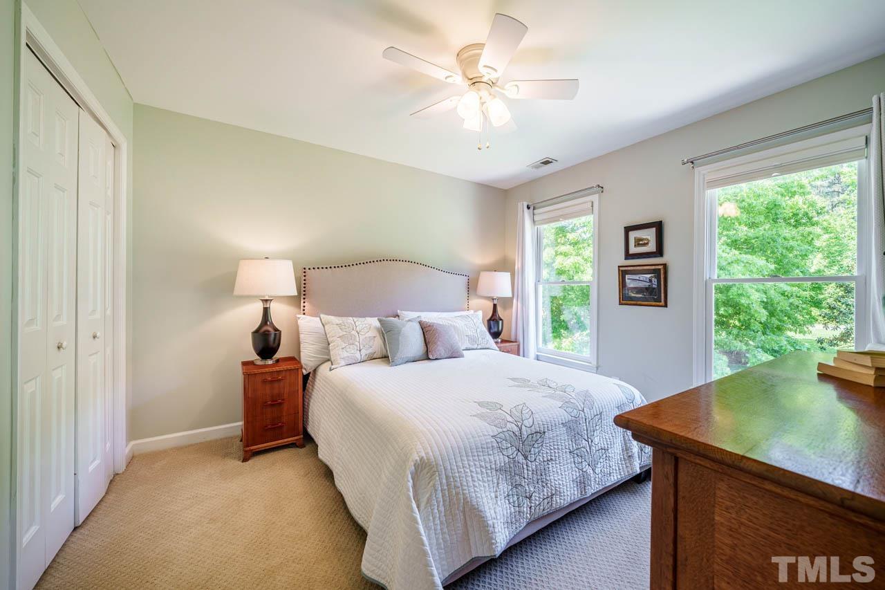 325 Morris Road Pittsboro, NC 27312 - Photo 22 of 39 a bedroom with a bed and a chandelier