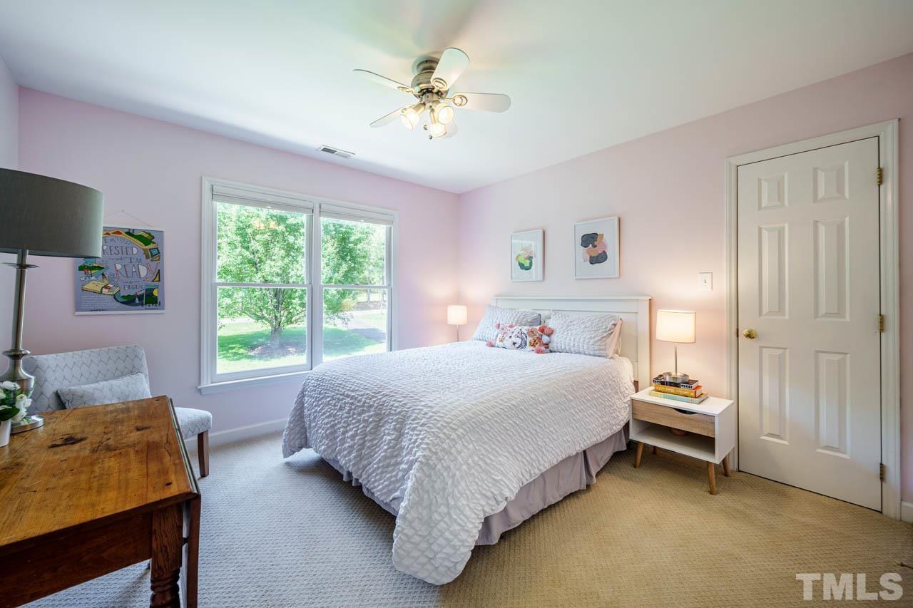 325 Morris Road Pittsboro, NC 27312 - Photo 23 of 39 a bedroom with a bed and a chandelier