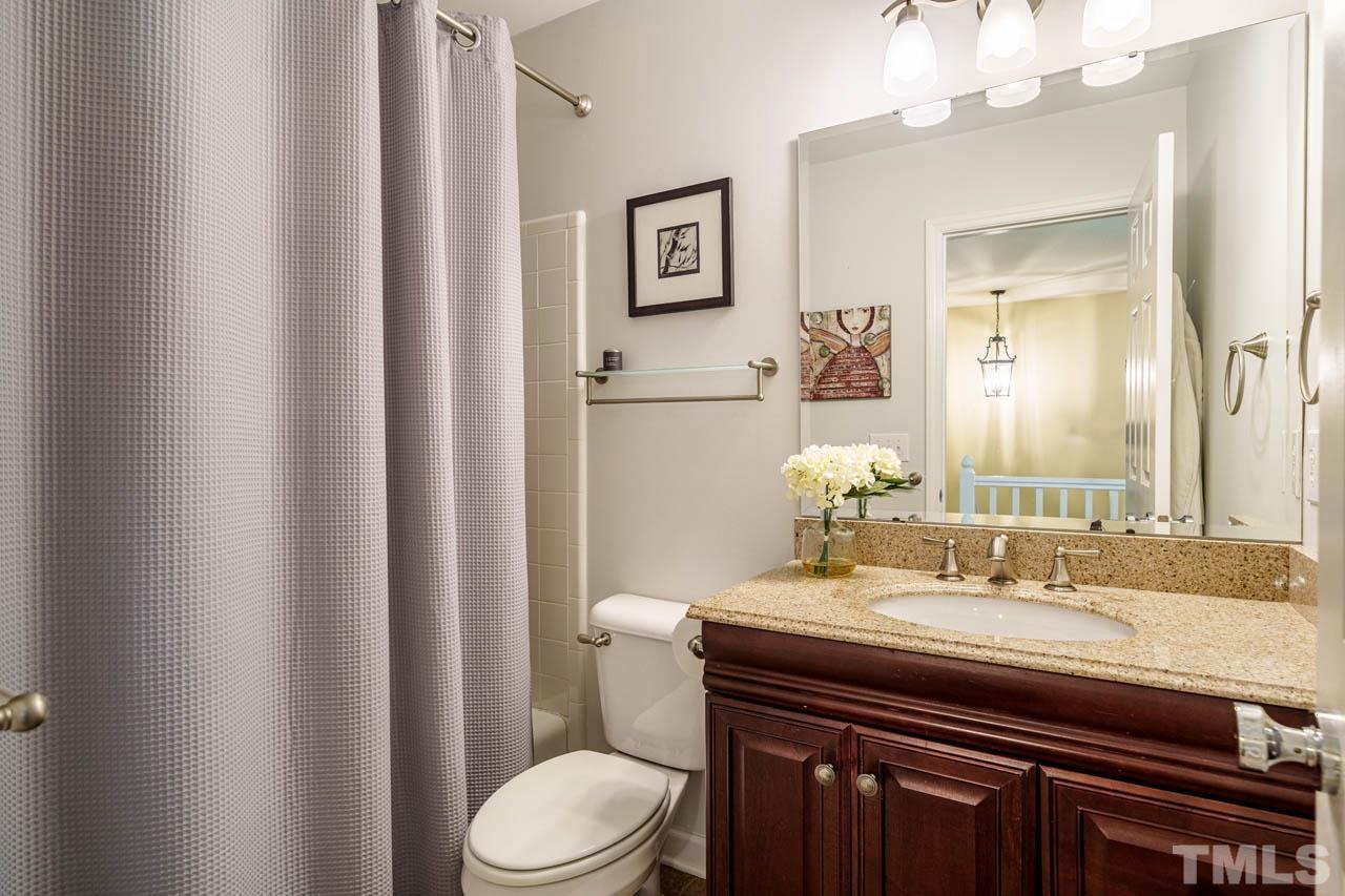 325 Morris Road Pittsboro, NC 27312 - Photo 25 of 39 a bathroom with a granite countertop sink toilet and mirror