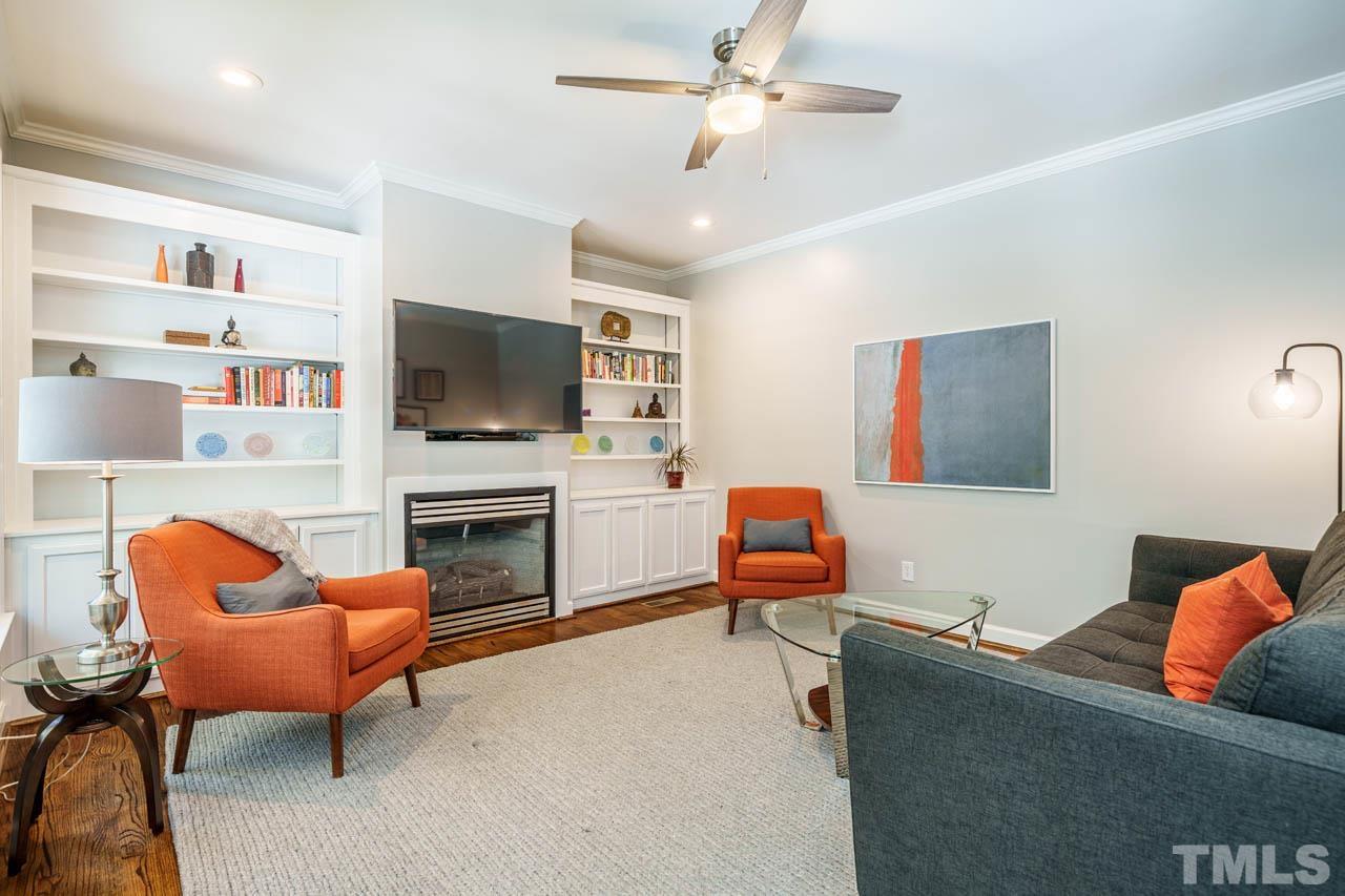 325 Morris Road Pittsboro, NC 27312 - Photo 7 of 39 a living room with furniture a fireplace and a flat screen tv