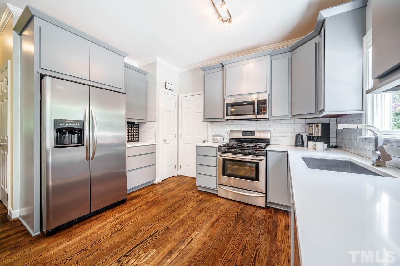 325 Morris Road Pittsboro, NC 27312 - Photo 9 of 39 a kitchen with granite countertop a refrigerator stove and microwave