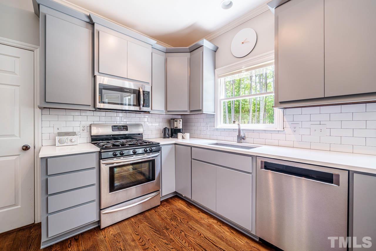 325 Morris Road Pittsboro, NC 27312 - Photo 10 of 39 a kitchen with stainless steel appliances white cabinets a sink and a stove
