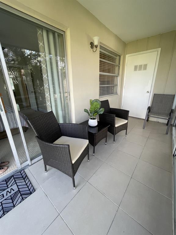 766 Normandy P, Unit 766 Delray Beach, FL 33484 - Photo 17 of 29 a living room with furniture and a window