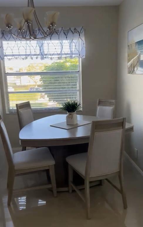 766 Normandy P, Unit 766 Delray Beach, FL 33484 - Photo 4 of 29 a view of a dining room with furniture