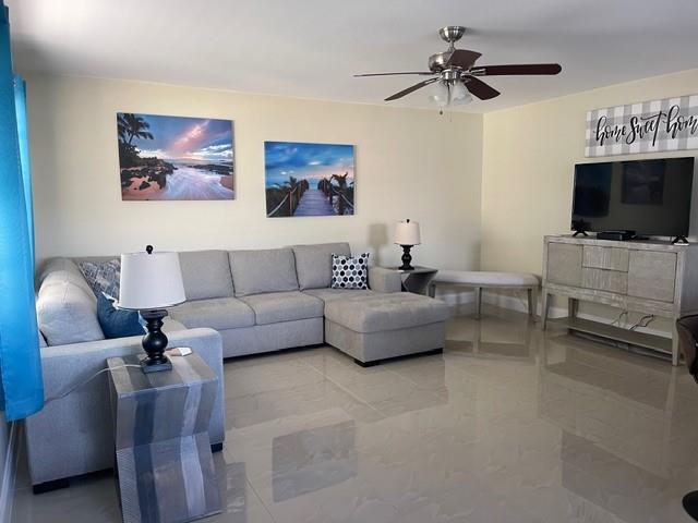 766 Normandy P, Unit 766 Delray Beach, FL 33484 - Photo 6 of 29 a living room with furniture and a flat screen tv