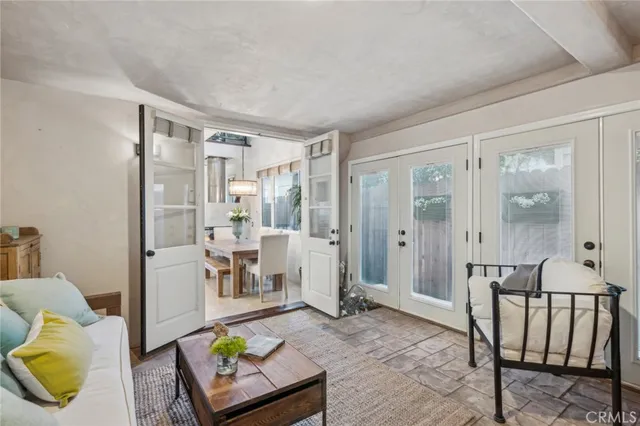 a kitchen with kitchen island granite countertop a table chairs sink and cabinets