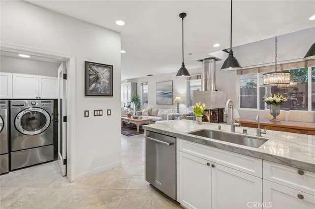 a kitchen with stainless steel appliances granite countertop a sink a stove and a wooden floors