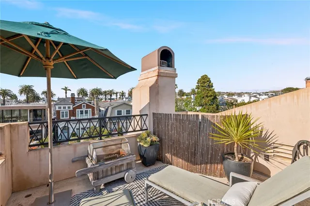 a view of a balcony with furniture and umbrella