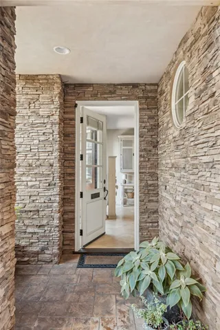 a living room with furniture and a painting on the wall