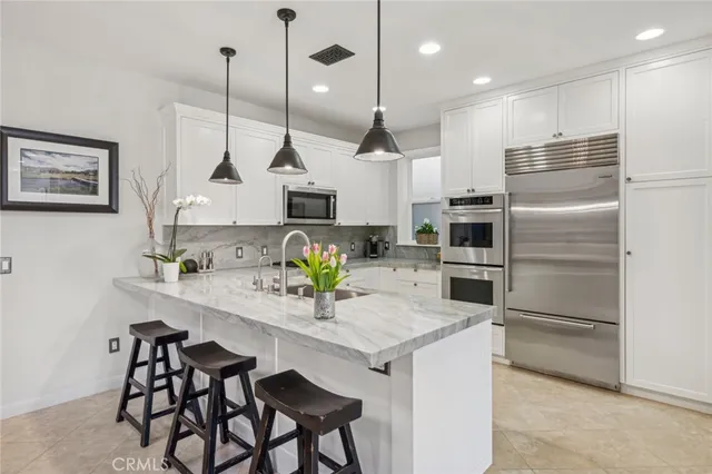 a kitchen with counter top space cabinets and stainless steel appliances
