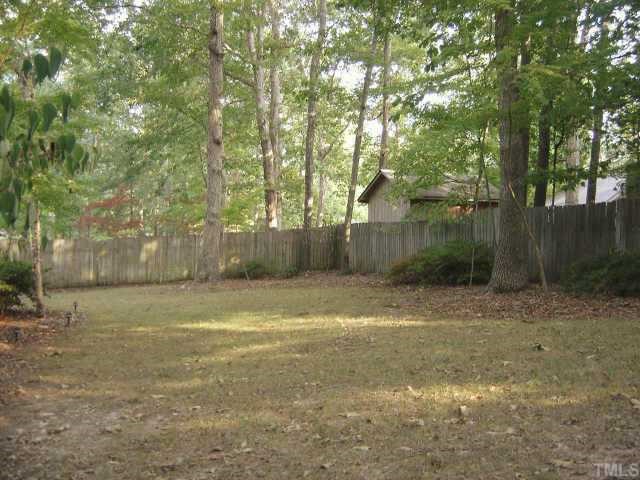 7405 Old Hundred Road Raleigh, NC 27613 - Photo 9 of 10 a backyard of a house with lots of green space