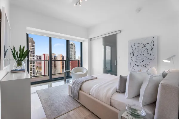 a bedroom with a balcony a bed and a couch