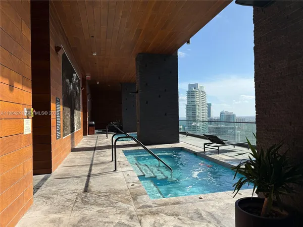 a swimming pool with outdoor seating and yard