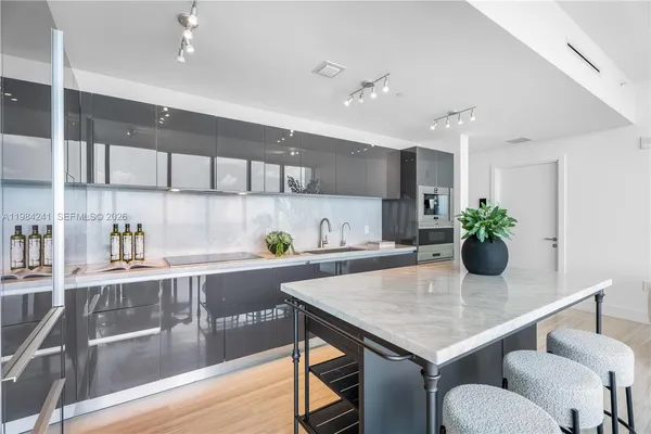 a kitchen with a table and chairs in it