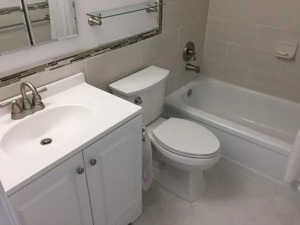 a bathroom with a sink a toilet and bathtub