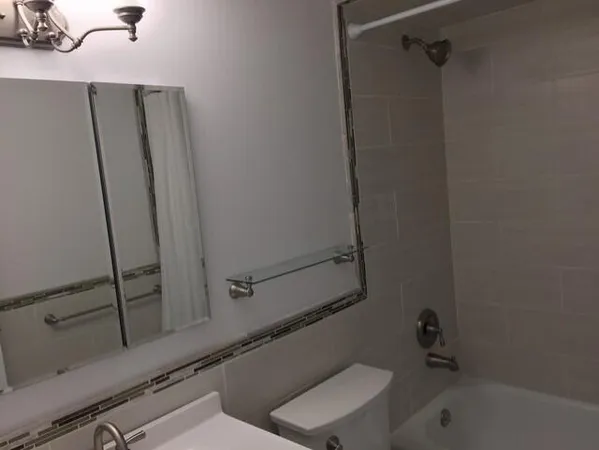 a bathroom with a tub and a sink