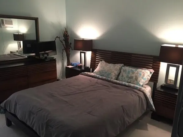 a bed room with a bed and a lamp