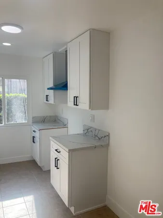 a utility room with cabinets washer and dryer