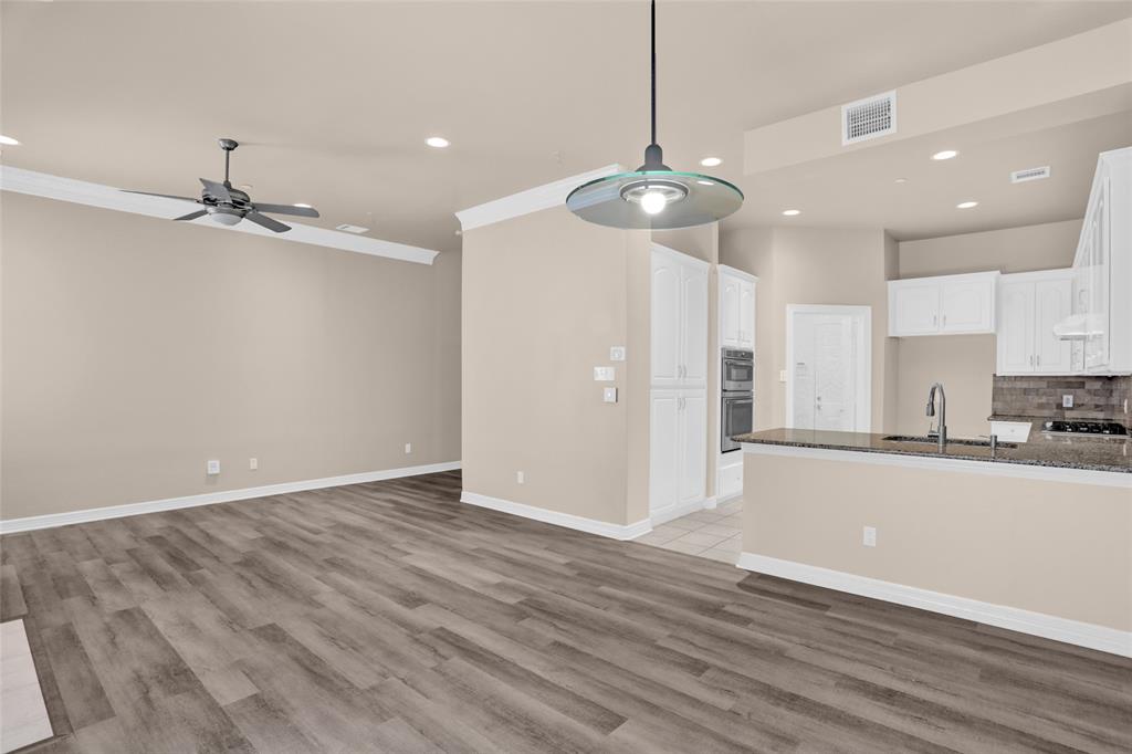 4092 Oberlin Way Addison, TX 75001 - Photo 12 of 40 Unfurnished living room featuring a ceiling fan, a sink, recessed lighting, light wood-style floors, and baseboards