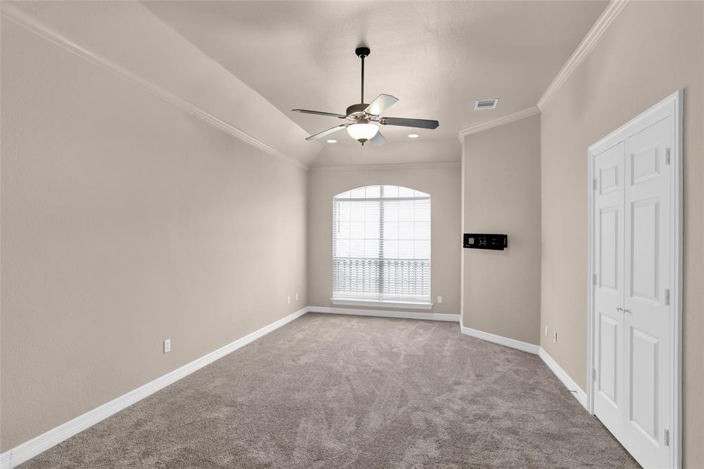 4092 Oberlin Way Addison, TX 75001 - Photo 20 of 40 Carpeted spare room with a ceiling fan, baseboards, ornamental molding, and lofted ceiling