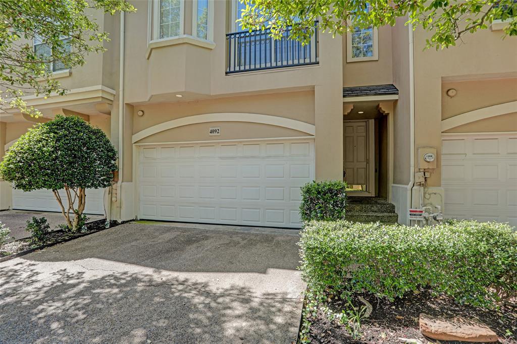 4092 Oberlin Way Addison, TX 75001 - Photo 2 of 40 View of front of home with a garage, stucco siding, a balcony, and concrete driveway