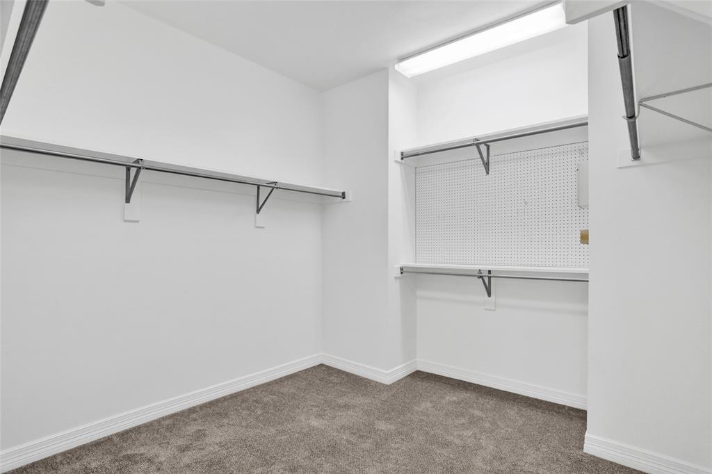 4092 Oberlin Way Addison, TX 75001 - Photo 23 of 40 Walk in closet with carpet floors
