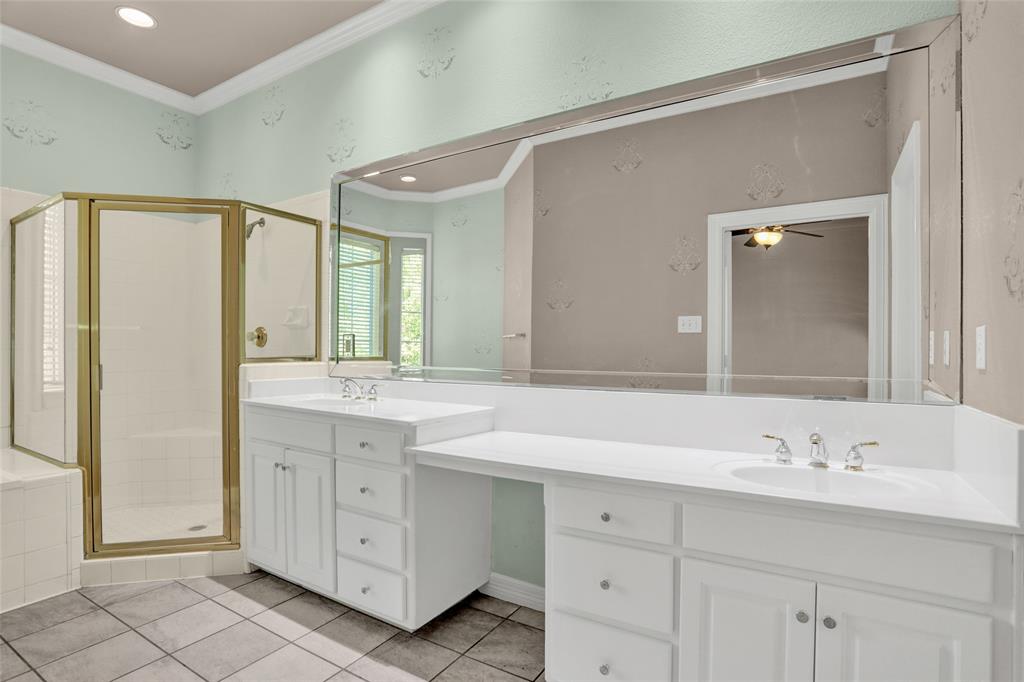 4092 Oberlin Way Addison, TX 75001 - Photo 24 of 40 Full bath featuring crown molding, a shower stall, tile patterned flooring, vanity, and ceiling fan