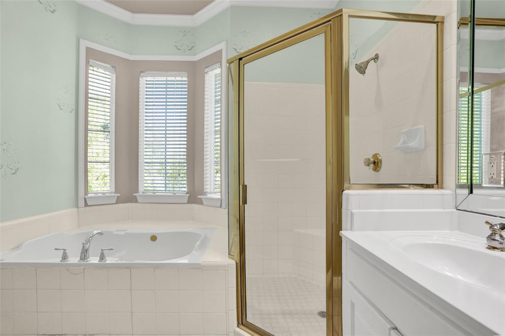 4092 Oberlin Way Addison, TX 75001 - Photo 25 of 40 Bathroom featuring a garden tub, a shower stall, healthy amount of natural light, vanity, and crown molding