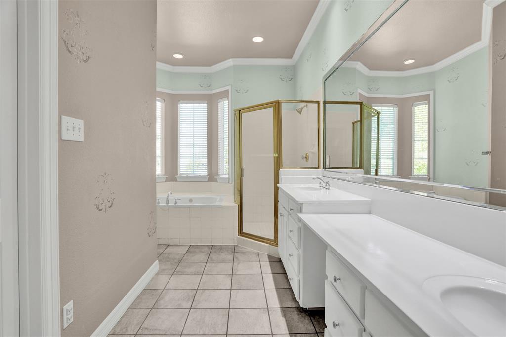 4092 Oberlin Way Addison, TX 75001 - Photo 26 of 40 Bathroom featuring healthy amount of natural light, a shower stall, a bath, double vanity, and crown molding