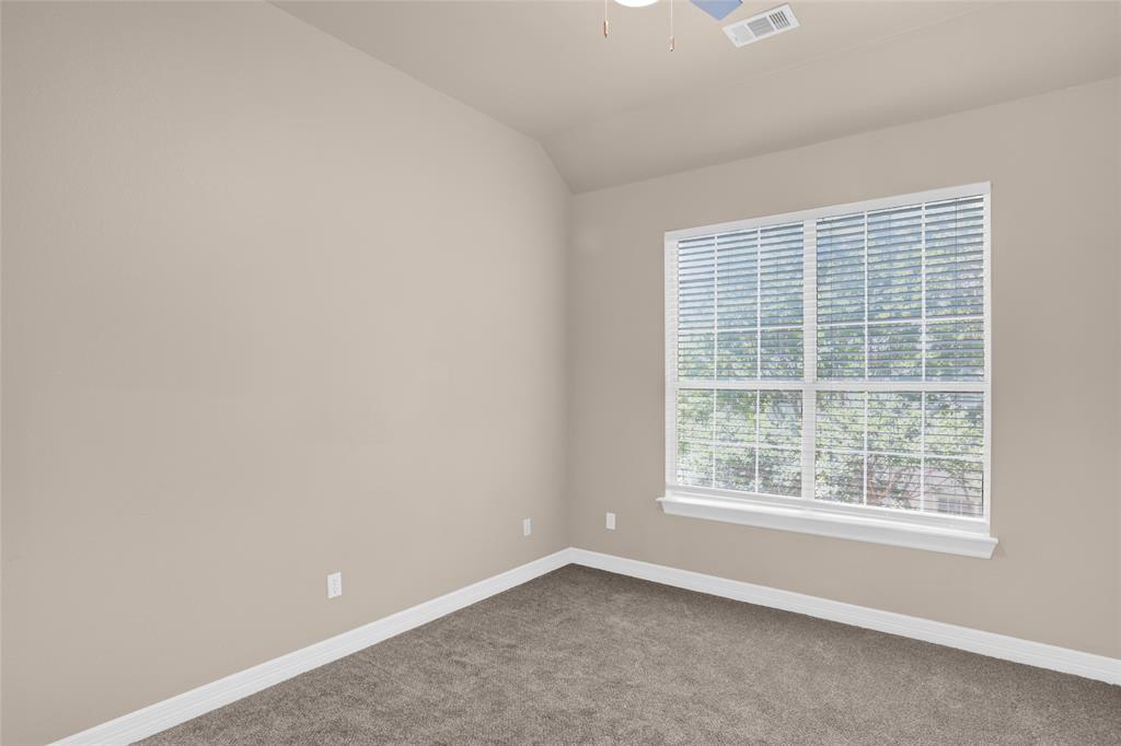 4092 Oberlin Way Addison, TX 75001 - Photo 27 of 40 Empty room featuring dark colored carpet, baseboards, a ceiling fan, and lofted ceiling