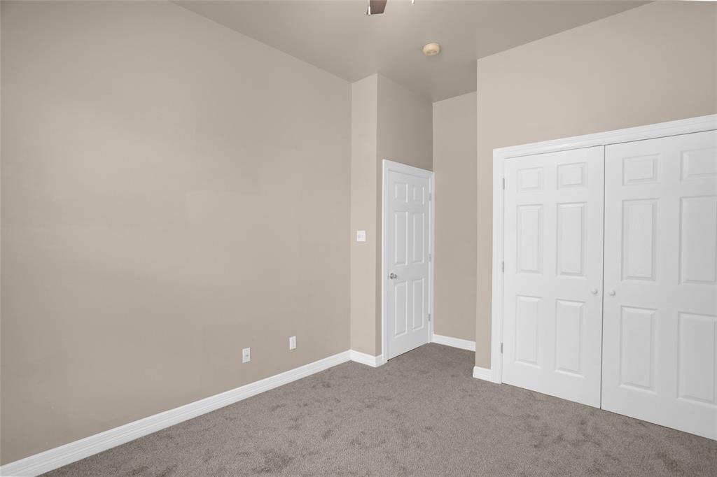 4092 Oberlin Way Addison, TX 75001 - Photo 29 of 40 Unfurnished bedroom featuring carpet floors, baseboards, a closet, and ceiling fan