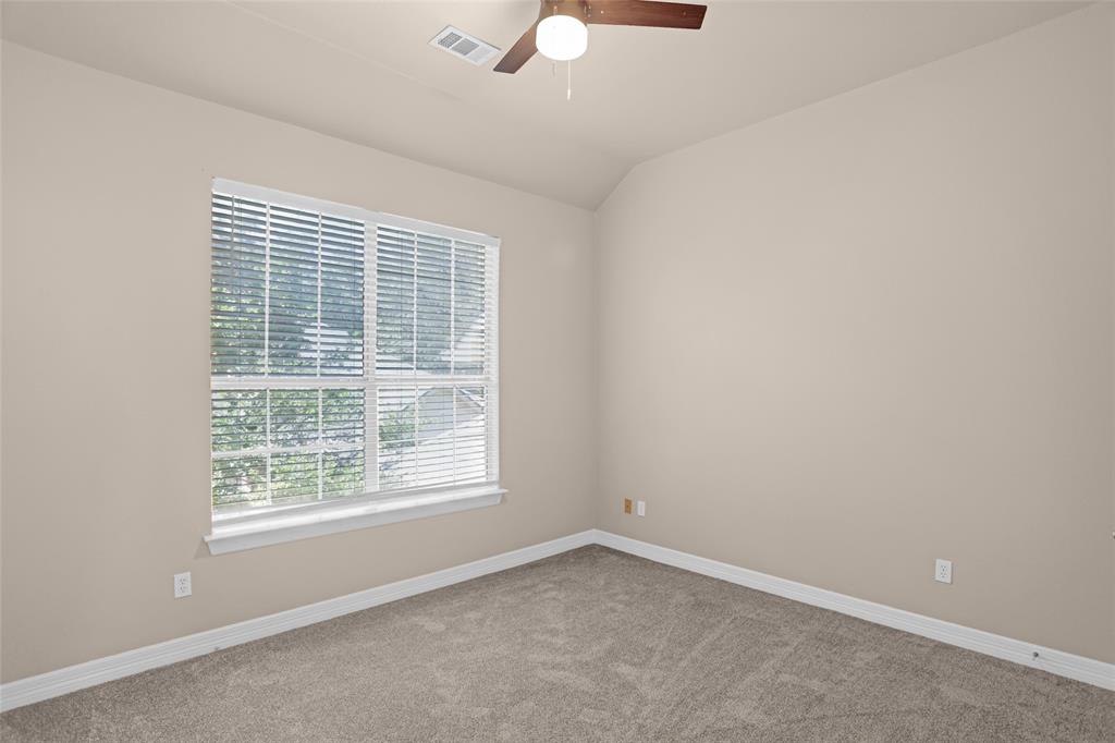 4092 Oberlin Way Addison, TX 75001 - Photo 30 of 40 Carpeted spare room with a ceiling fan, baseboards, and vaulted ceiling