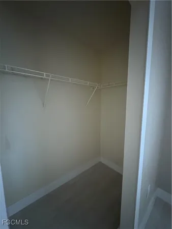 an empty room with a ceiling fan and window