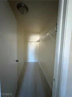a bathroom with a granite countertop toilet a sink and a mirror