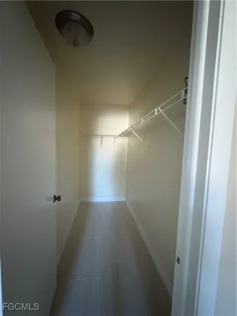 a bathroom with a granite countertop toilet a sink and a mirror