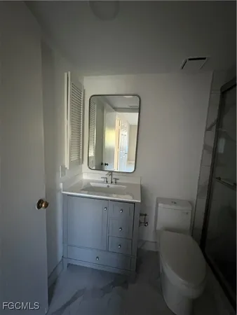 a bathroom with a shower and a toilet