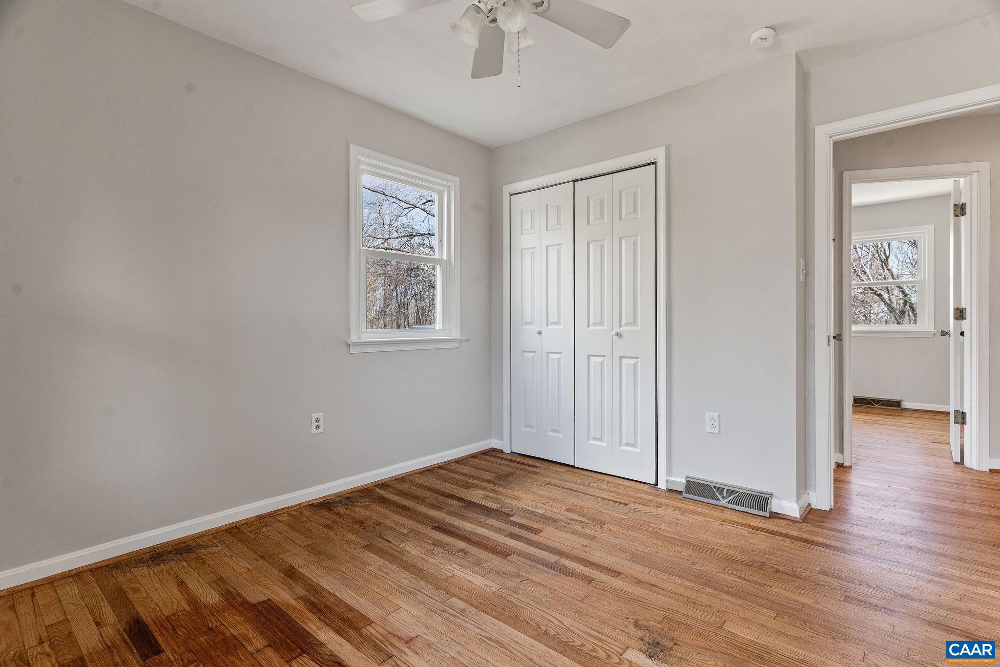 569 Half Mile Branch Road Crozet, VA 22932 - Photo 13 of 35 wooden floor in an empty room with a window