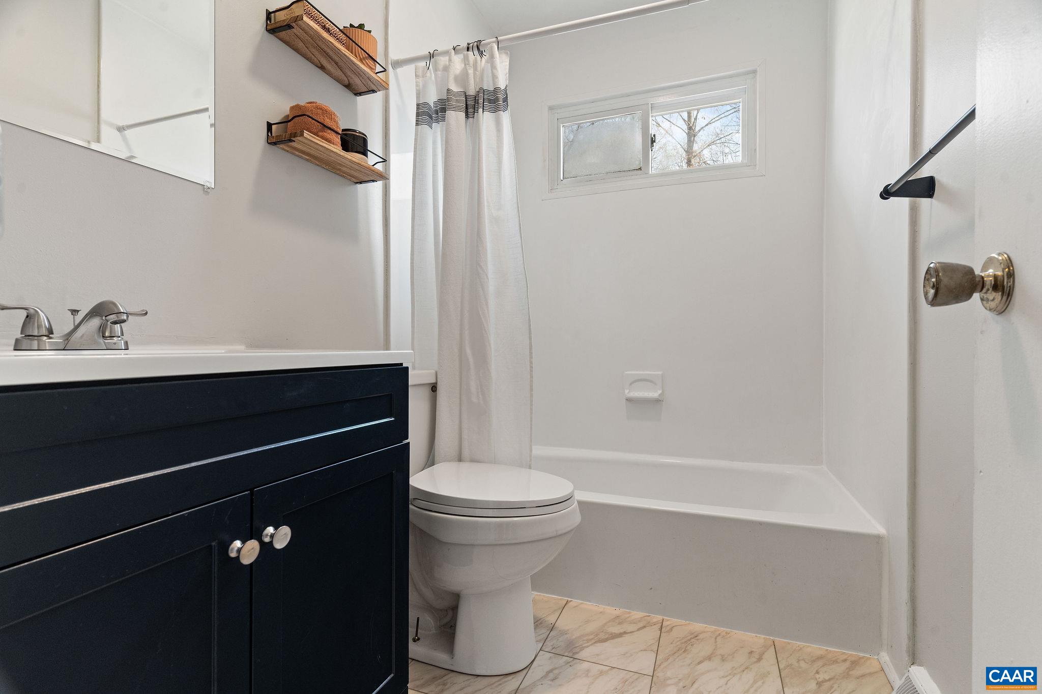 569 Half Mile Branch Road Crozet, VA 22932 - Photo 16 of 35 a bathroom with a sink a toilet and shower