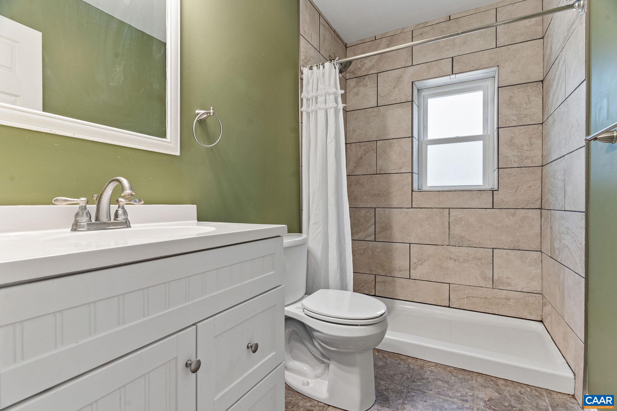 569 Half Mile Branch Road Crozet, VA 22932 - Photo 22 of 35 a bathroom with a sink a toilet and shower