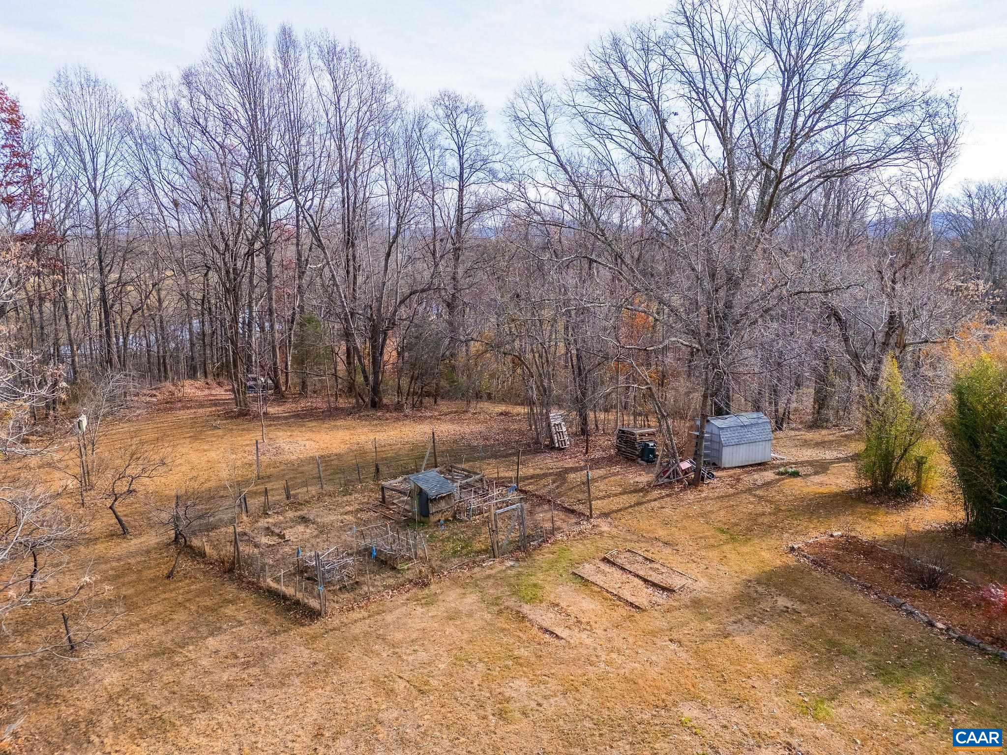 569 Half Mile Branch Road Crozet, VA 22932 - Photo 31 of 35 a backyard of a house with trees and houses