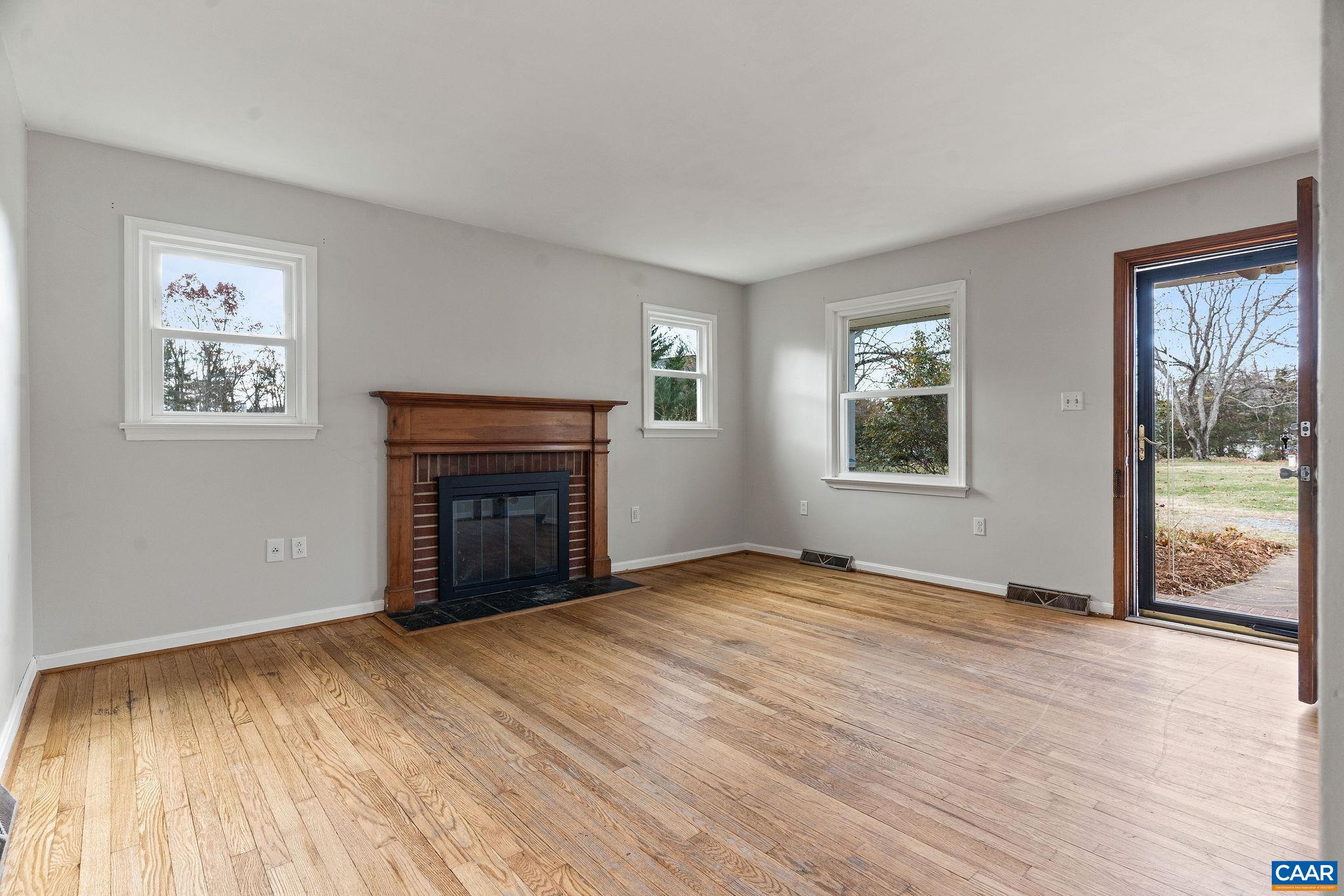 569 Half Mile Branch Road Crozet, VA 22932 - Photo 6 of 35 a view of an empty room with a window and wooden floor