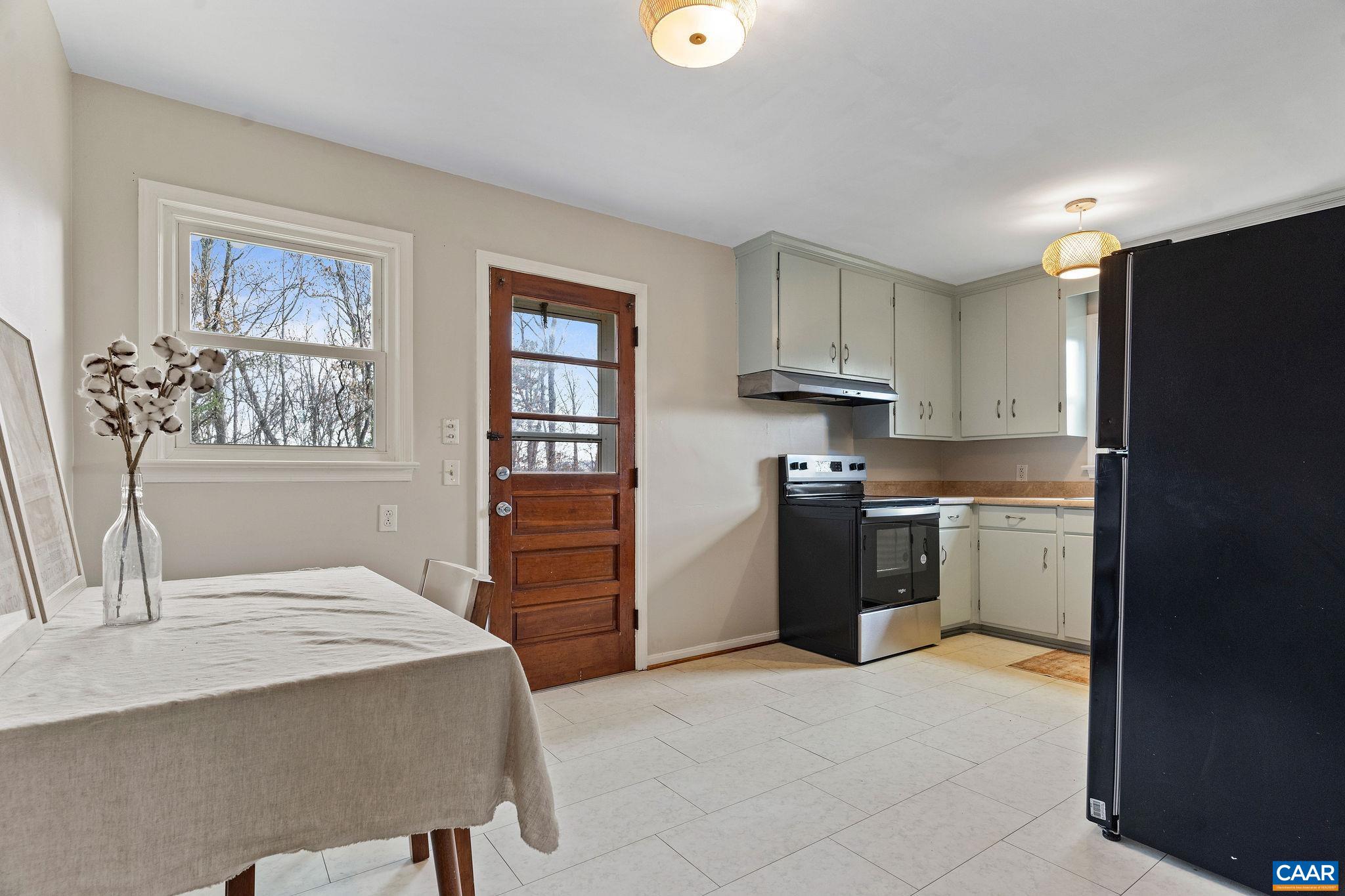 569 Half Mile Branch Road Crozet, VA 22932 - Photo 7 of 35 a kitchen with a refrigerator and a stove top oven