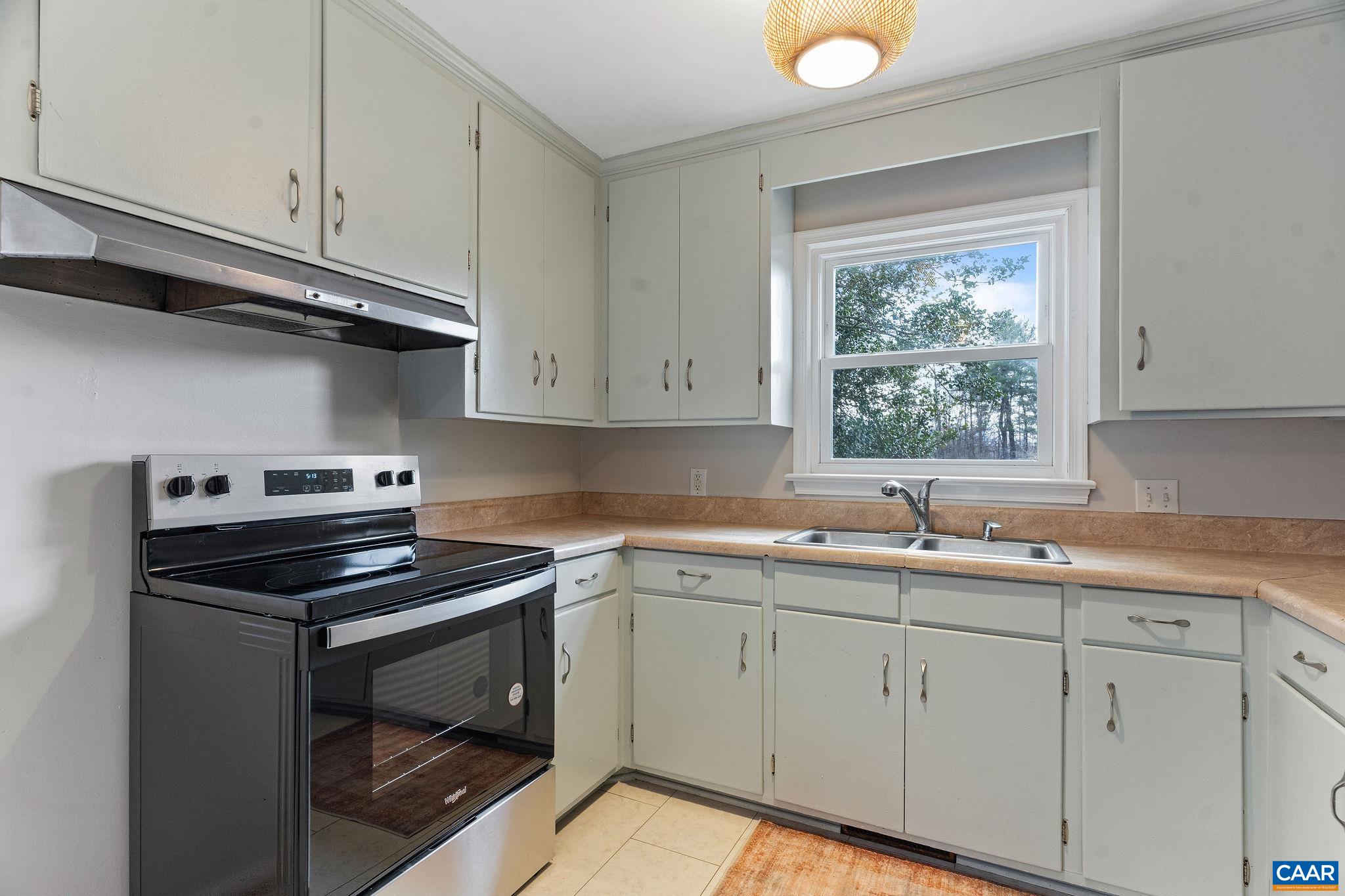 569 Half Mile Branch Road Crozet, VA 22932 - Photo 8 of 35 a kitchen with a sink stove and cabinets