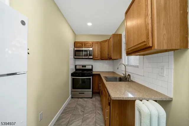 a kitchen with stainless steel appliances a stove a sink and a microwave