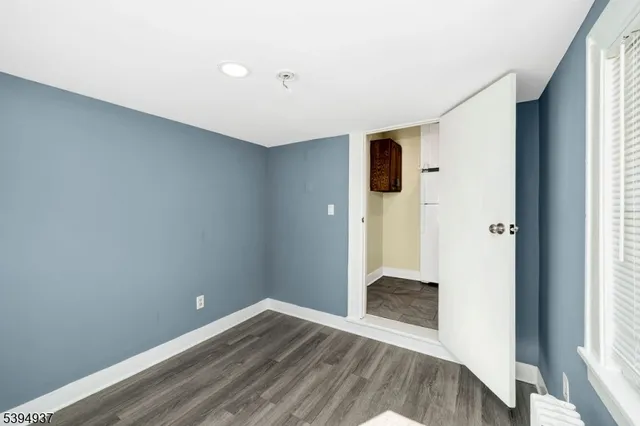 a view of entryway with wooden floor and front door