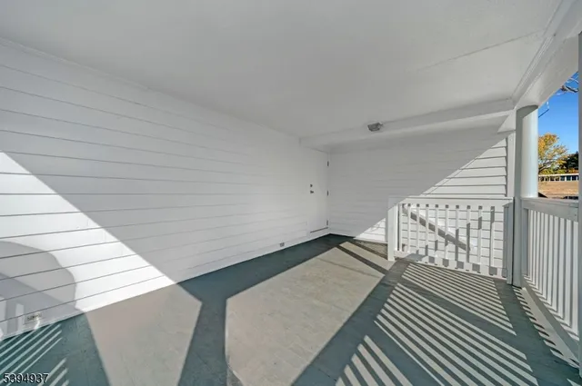 a view of an empty room and wooden floor