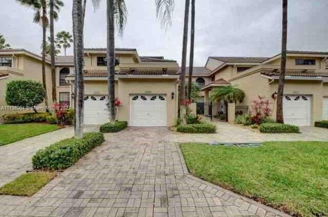 6765 Montego Bay Boulevard, Unit E Boca Raton, FL 33433 - Photo 1 of 31 a front view of a house with a yard